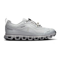 A light gray and white athletic sneaker with a chunky, segmented sole, shown in a side profile on a white background.