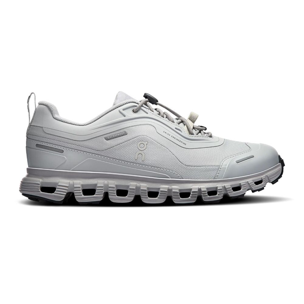 A light gray and white athletic sneaker with a chunky, segmented sole, shown in a side profile on a white background.
