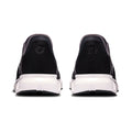 A pair of black slip-on sneakers shown from the back, featuring a thick white midsole and a small circular logo on the heel counter, set against a plain white background.