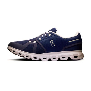A navy blue On running shoe with white laces, white logo detailing, and a white cushioned sole, shown in a side profile on a white background.
