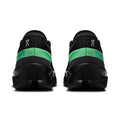 Black and green athletic shoes on a white background