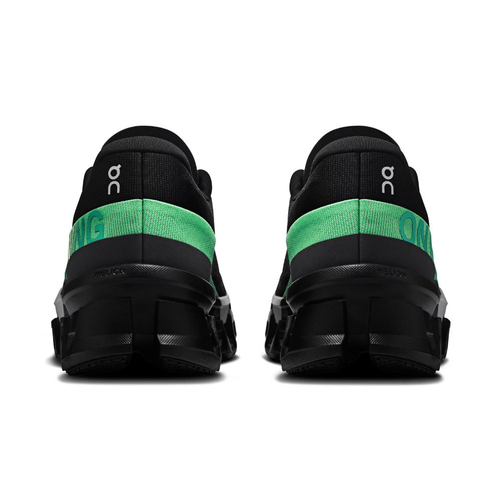 Black and green athletic shoes on a white background