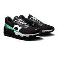 A pair of black On Cloudrunning shoes with a distinctive green and white side stripe, white laces, and a white midsole, shown on a clean white background.