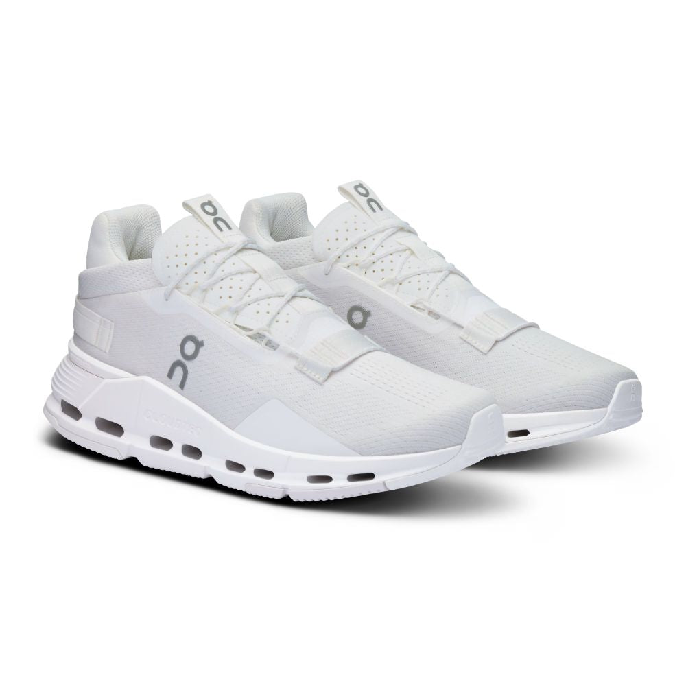 A white On running shoe shown from the side against a plain white background, featuring a white mesh upper, white laces, a white midsole with visible air pockets, and a gray On logo on the side.