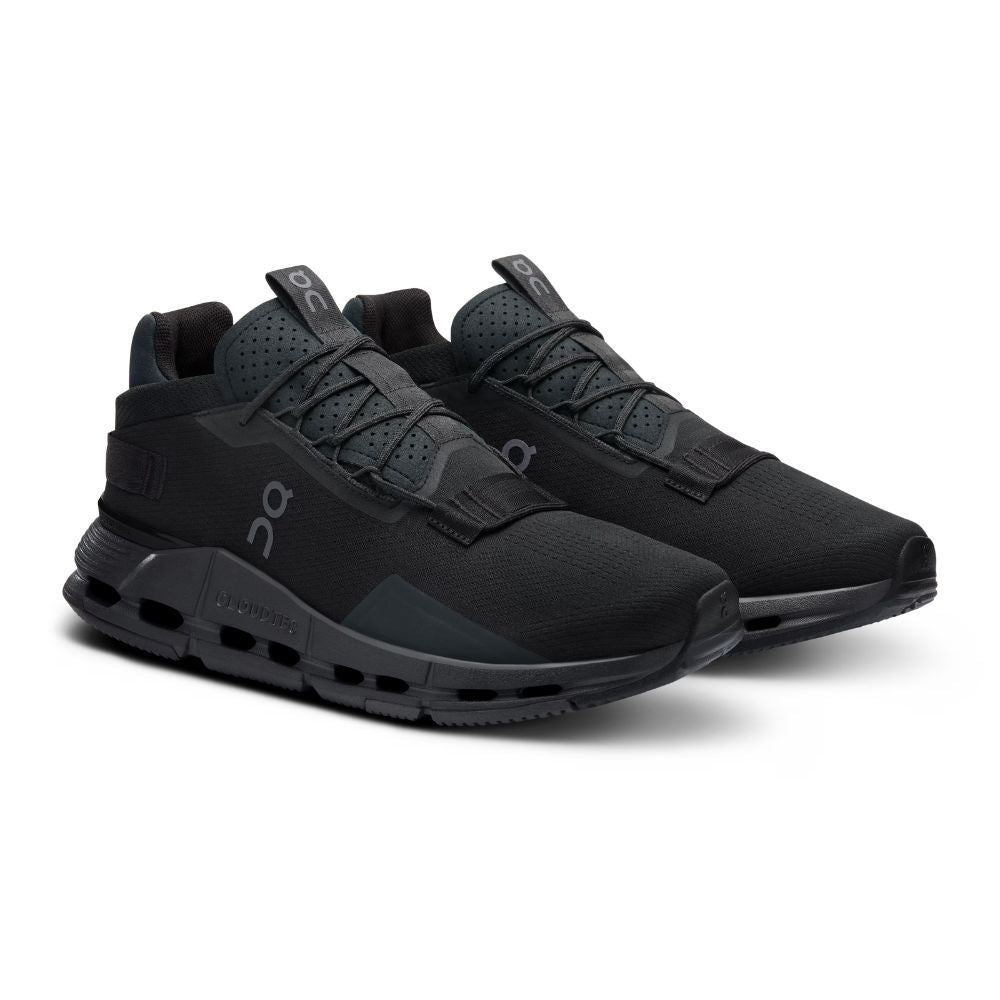 A pair of On Cloudrunner sneakers in an all-black colorway, featuring a textured mesh upper, integrated laces, and a chunky cushioned sole with visible air pockets, set against a plain white background.