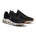 A pair of black On running shoes with a white midsole and gum outsole, shown on a clean white background.