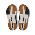 Top-down view of a pair of athletic shoes showing the textured brown, white, and black outsoles against a white background.