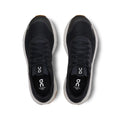 Black running shoes with 'on' branding on a white background
