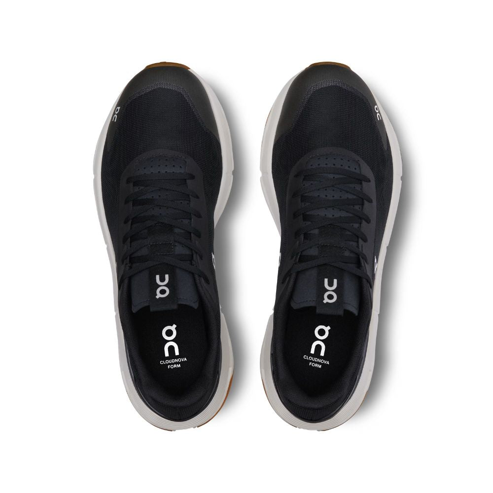 Black running shoes with 'on' branding on a white background