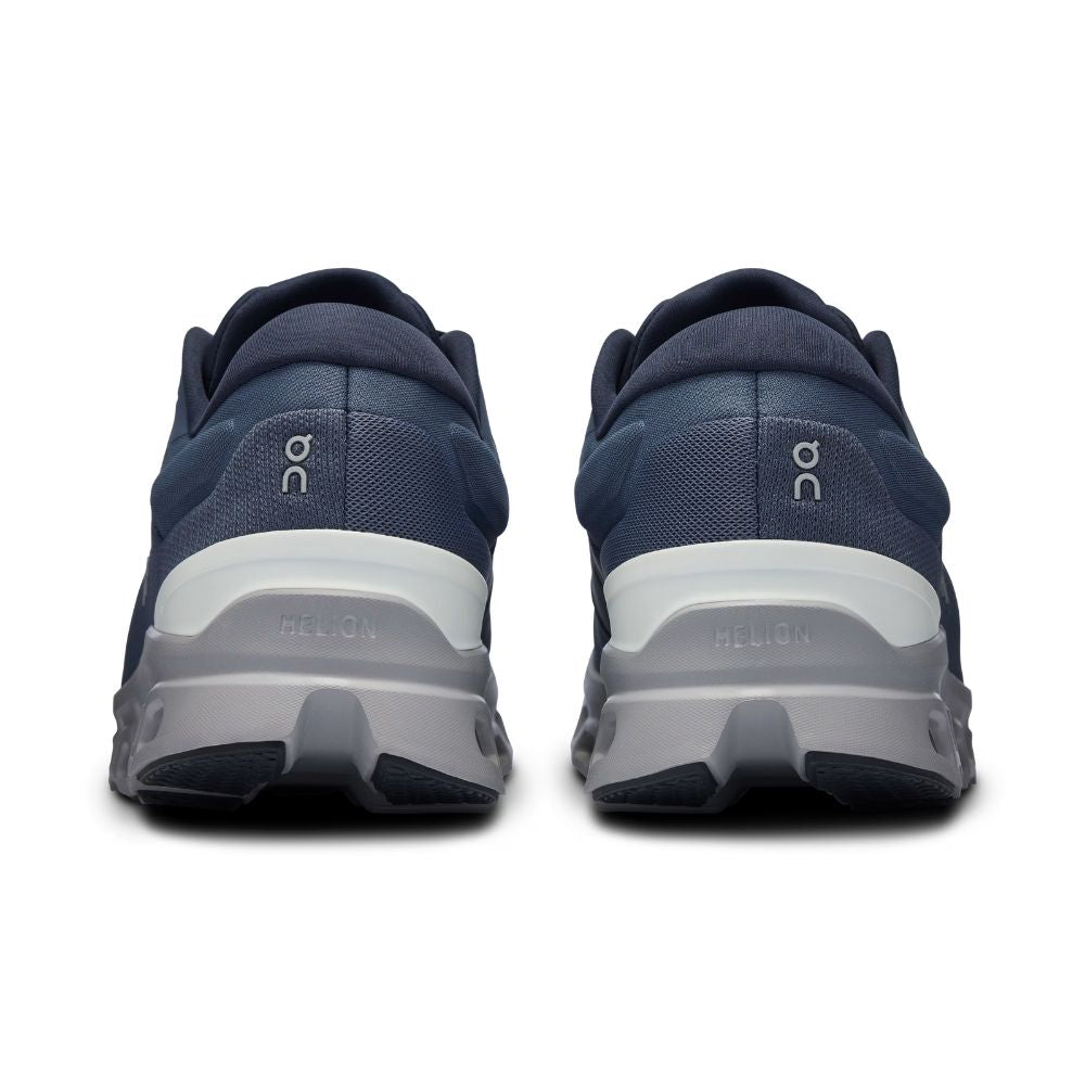 A pair of navy blue athletic sneakers shown from the rear, featuring a thick white and gray midsole and the 'on' logo on the heel.
