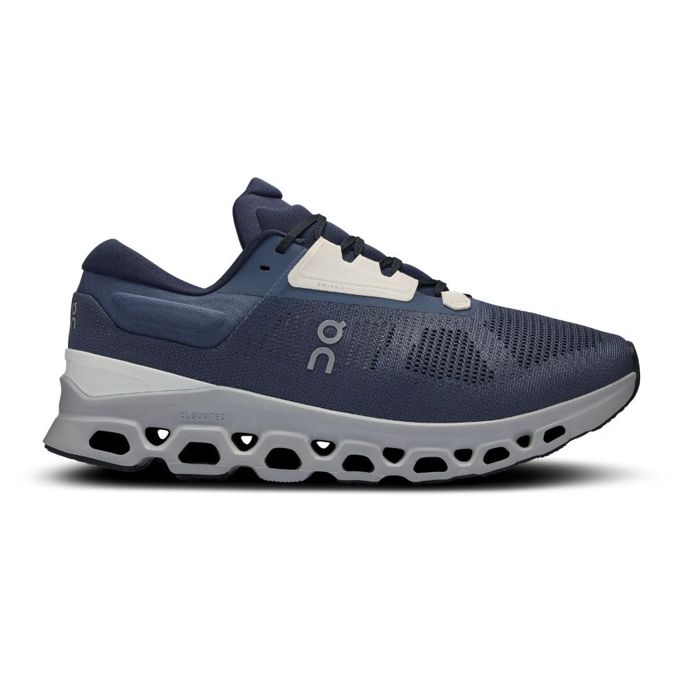 A navy blue On running shoe with a white and gray CloudTec sole, shown in a side profile on a white background.