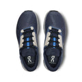 Pair of blue running shoes with white soles on a white background