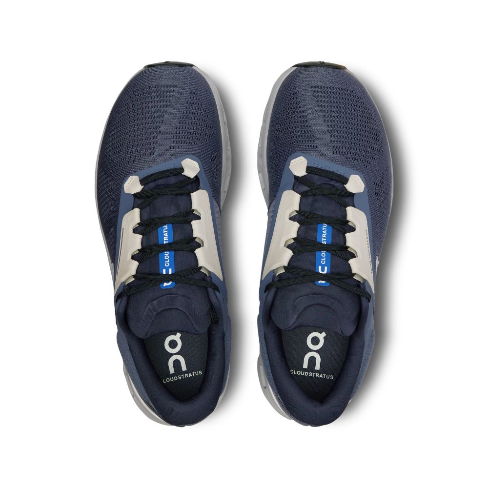 Pair of blue running shoes with white soles on a white background