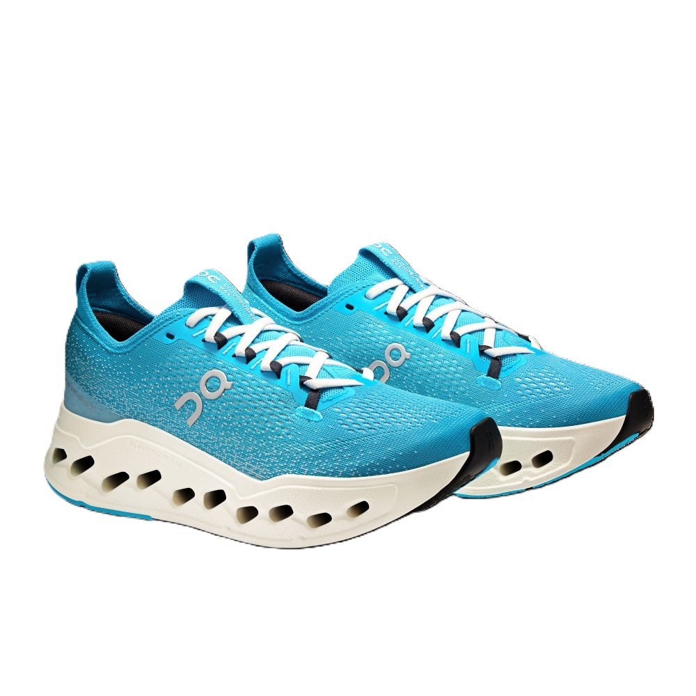 Blue running shoes with white soles on a white background
