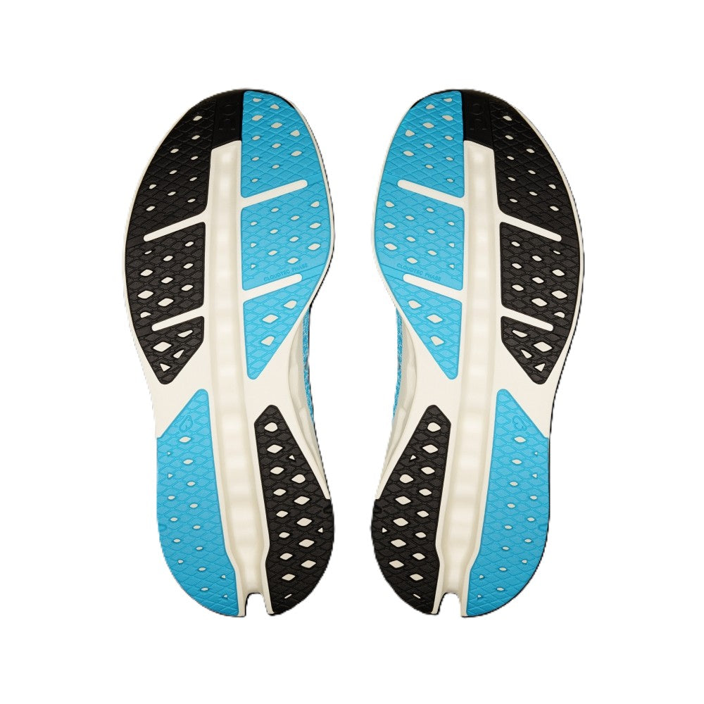 A pair of athletic shoe soles shown from the bottom, featuring a color-blocked design with bright blue, black, and off-white sections.