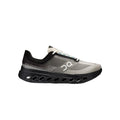 A single On running shoe in gray and black with a distinctive black sole featuring circular cutouts, shown from a side profile on a white background.