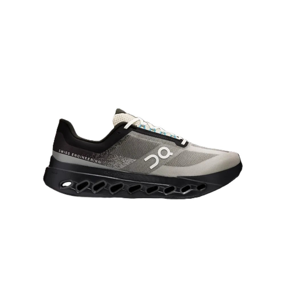 A single On running shoe in gray and black with a distinctive black sole featuring circular cutouts, shown from a side profile on a white background.