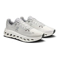 A pair of On Cloudrunning shoes in white and light gray, featuring a cushioned midsole with cutouts and the On logo on the side, set against a plain white background.