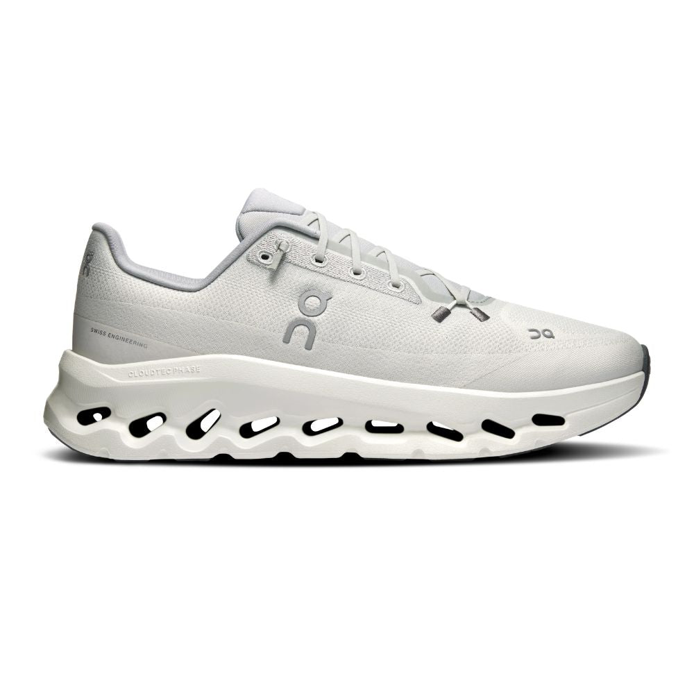 A white On Cloudrunner sneaker with a chunky, sculpted midsole featuring circular cutouts, shown in a side profile on a white background.