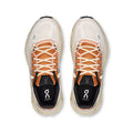 A pair of On Cloudrunning sneakers shown from a top-down view. The shoes feature a light beige mesh upper, peach-colored laces, a black insole lining with the white On logo, and a thick beige midsole.