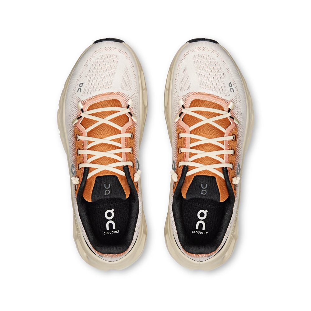 A pair of On Cloudrunning sneakers shown from a top-down view. The shoes feature a light beige mesh upper, peach-colored laces, a black insole lining with the white On logo, and a thick beige midsole.