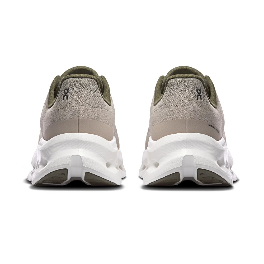 A pair of On running shoes shown from the back, featuring a light taupe knit upper, olive green collar details, and a chunky white midsole with dark gray outsole accents.