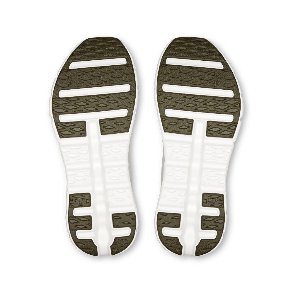 A pair of athletic shoe soles shown from the bottom, featuring a white midsole with cutouts and an olive green outsole with textured tread patterns.