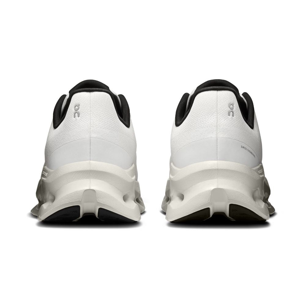 A pair of white On running shoes shown from the back, featuring black accents on the collar, tongue, and outsole, with the On logo visible on the heel.