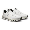 A pair of white On running shoes with black accents, including the tongue, heel, and outsole details, displayed on a clean white background.