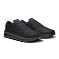A pair of black athletic sneakers with a matching black sole, shown from a three-quarters angle on a white background.