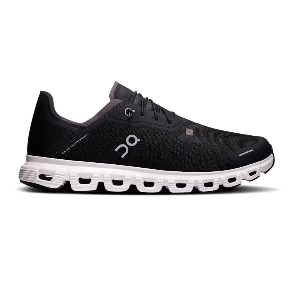 Navy running shoe with white sole on a white background
