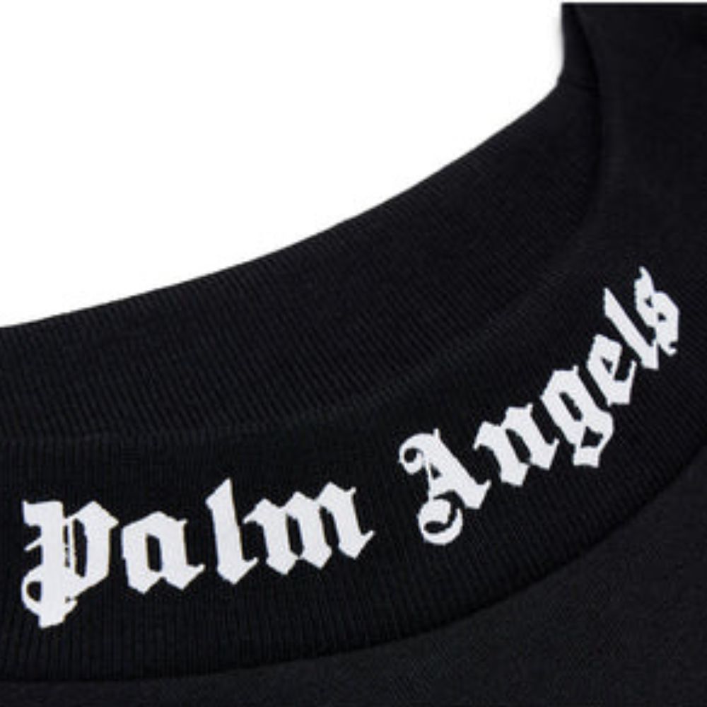 Close-up of a black knit collar with white Gothic-style 'Palm Angels' lettering across the neck.