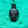 Omega watch on a textured teal surface