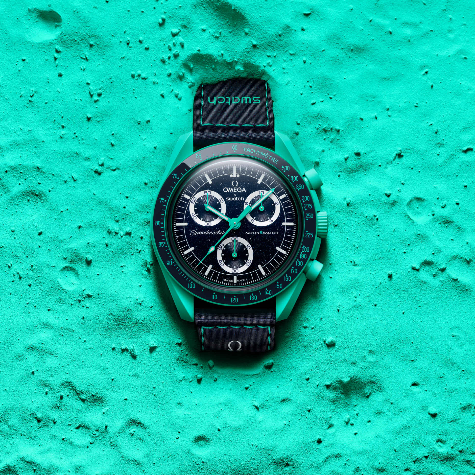 Omega watch on a textured teal surface
