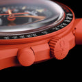 Close-up of a red watch with detailed design on a black background