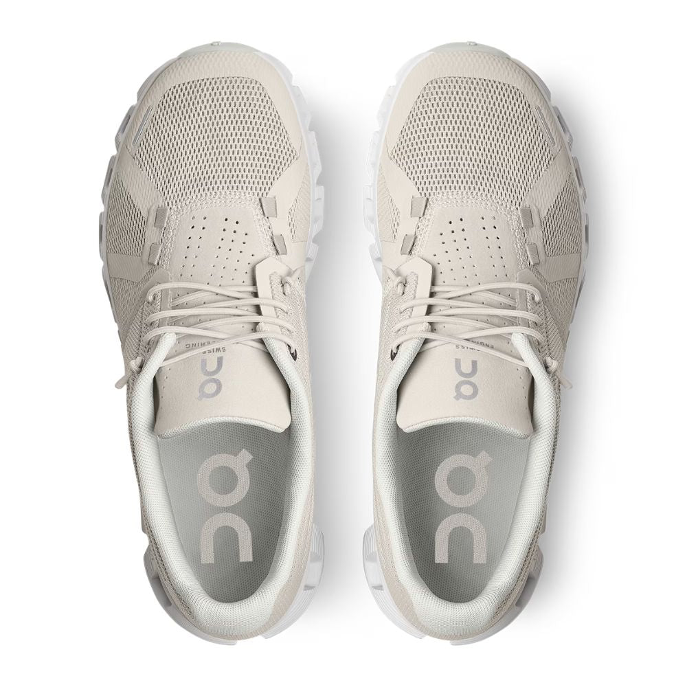 A pair of off-white mesh athletic sneakers shown from a top-down view on a clean white background. The brand 'on' is visible on the tongue and insole.