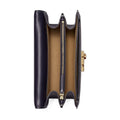 A navy blue leather clutch wallet shown open, displaying its tan interior lining, gold-tone zipper, and gold-tone clasp on a plain white background.